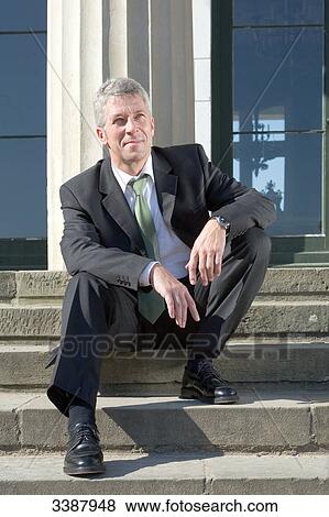 Businessman sitting on stairs View Large Photo Image Stock Photo - Businessman sitting on stairs . Fotosearch