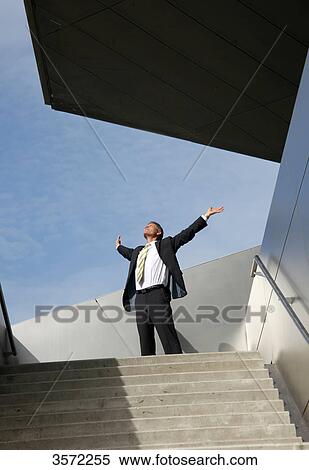 Stock Photography - Businessman spreading his arms outdoors . Fotosearch