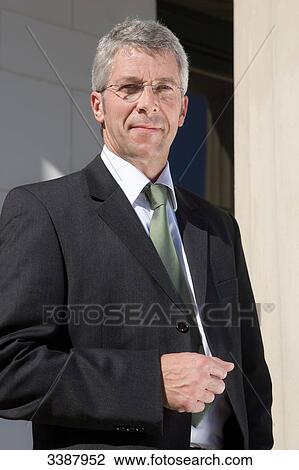 Stock Image - Businessman with glasses smiling at camera . Fotosearch