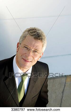 Businessman with glasses smiling at camera View Large Photo Image Stock Photo - Businessman with glasses smiling at camera . Fotosearch