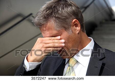 Businessman with hand on his face View Large Photo Image Stock Photo - Businessman with hand on his face . Fotosearch