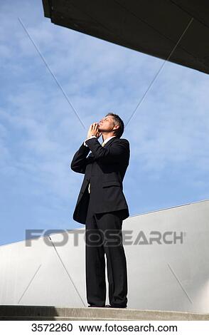 Businessman with hands folded outdoors View Large Photo Image Stock Image - Businessman with hands folded outdoors . Fotosearch