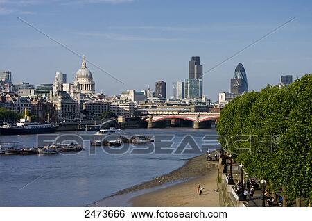 Stock Photograph - Cathedral in city, St. Paul's Cathedral, Thames River, City Of London, London, England . Fotosearch