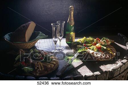 Stock Photograph - Champagne flutes with Champagne bottle on table . Fotosearch