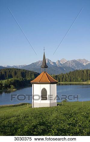 Stock Photography - Chapel at the lake of Hegratsried near Halblech, Allgau, Germany . Fotosearch