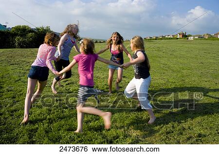 Children playing ring-a-ring-o-roses in field View Large Photo Image Stock Photograph - Children playing ring-a-ring-o-roses in field . Fotosearch
