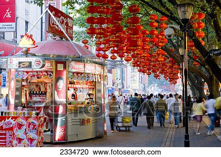Stock Image - Chinese lanterns hanging on tree in street, Guangzhou, Guangdong Province, China . Fotosearch
