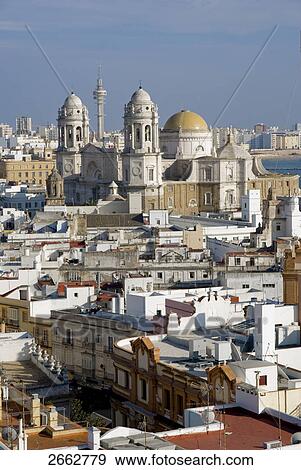 Stock Photo - Church and houses in city, Costa de la Luz, Cadiz, Andalusia, Spain . Fotosearch