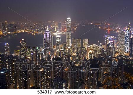 Stock Photo - City lit up at waterfront, Hong Kong, China . Fotosearch