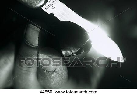 Close-up of human hand holding penknife View Large Photo Image Stock Image - Close-up of human hand holding penknife . Fotosearch