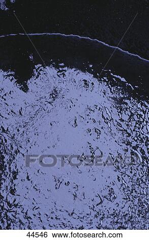 Stock Photograph - Close-up of waste oil in barrel . Fotosearch