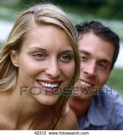 Stock Image - Close-up of young couple smiling . Fotosearch