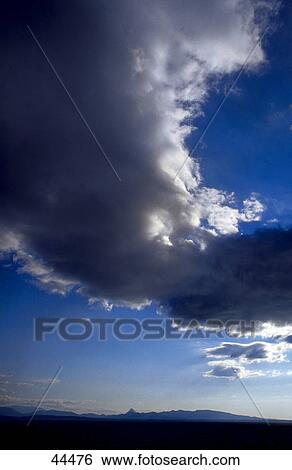 Stock Photograph - Clouds above landscape . Fotosearch