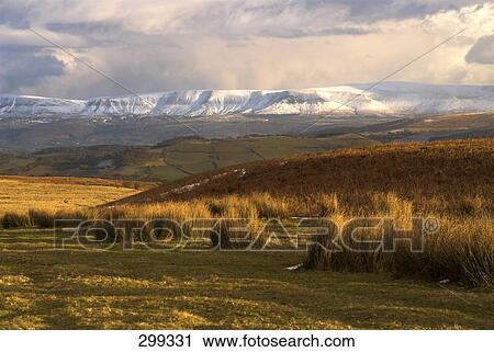 Clouds over snowcapped mountains, Powys, Wales View Large Photo Image Stock Image - Clouds over snowcapped mountains, Powys, Wales . Fotosearch