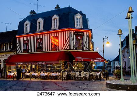 Stock Photo - Coffee shop lit up at dusk, Deauville, Cote Fleurie, Basse-Normandy, Normandy, France . Fotosearch