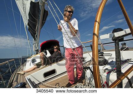 Couple on the deck of a sailing yacht View Large Photo Image Stock Image - Couple on the deck of a sailing yacht . Fotosearch