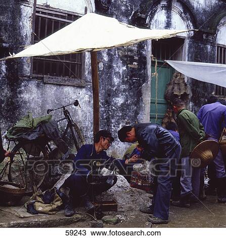 Stock Image - Craftsman at street market, China . Fotosearch