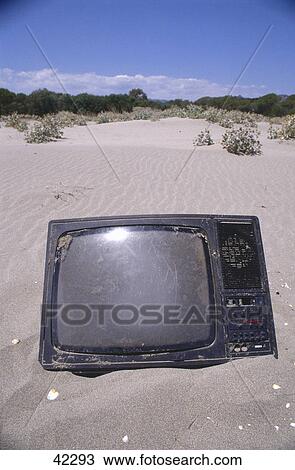 Stock Image - Damaged television on beach, Sardinia, Italy . Fotosearch
