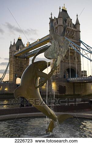 Dolphin sculpture with bridge in background, Tower Bridge, Thames River, London, England View Large Photo Image Stock Image - Dolphin sculpture with bridge in background, Tower Bridge, Thames River, London, England . Fotosearch