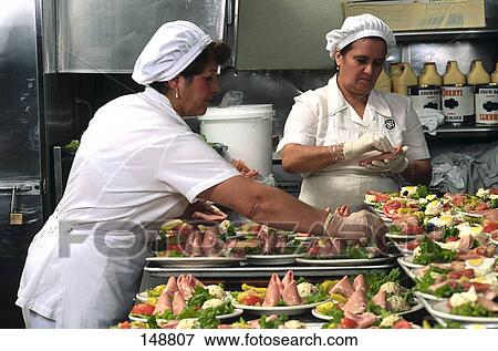 Stock Photo - Female chefs preparing salad . Fotosearch