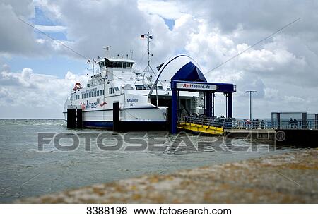 Stock Photo - Ferry and passengers on the gangway at the harbour of List, Sylt, Germany . Fotosearch