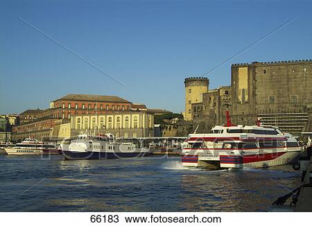 Stock Image - Ferryboats at harbor, Castel Nuovo, Campania, Naples, Italy . Fotosearch