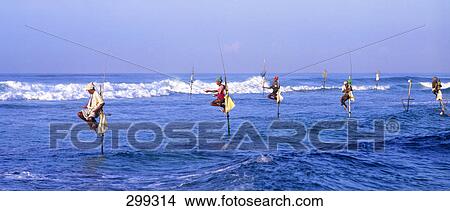 Picture - Fisherman fishing on beach . Fotosearch