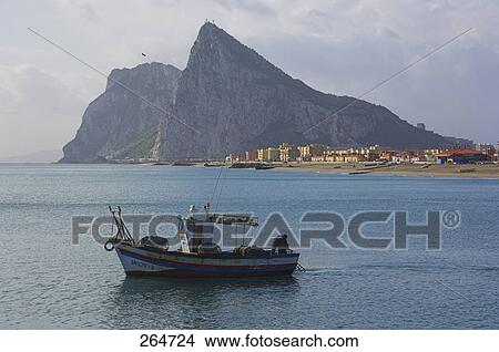 Fishing boat in bay with rock formation in background, Rock of Gibraltar, Bay of Gibraltar, Spain View Large Photo Image Picture - Fishing boat in bay with rock formation in background, Rock of Gibraltar, Bay of Gibraltar, Spain . Fotosearch