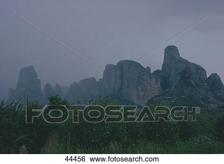 Stock Photograph - Fog covered cliffs in forest near Meteora Cloisters, Greece . Fotosearch
