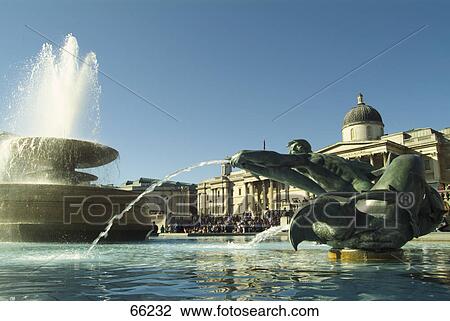 Stock Image - Fountain at city square, Trafalgar Square, London, England . Fotosearch