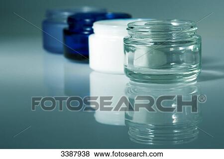 Four cream jars in a row, close-up View Large Photo Image Stock Photo - Four cream jars in a row, close-up . Fotosearch