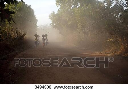 Stock Photo - Four women carrying goods on her head, Gambia, West Africa, Africa . Fotosearch