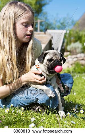 Girl playing with pug View Large Photo Image Stock Image - Girl playing with pug . Fotosearch