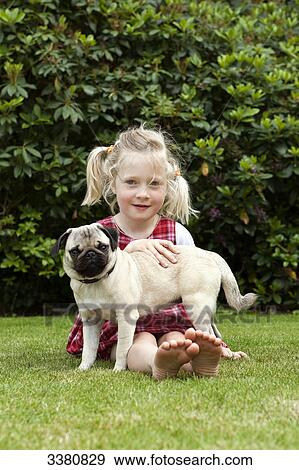 Girl sitting with pug on lawn View Large Photo Image Stock Photo - Girl sitting with pug on lawn . Fotosearch