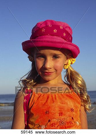 Girl with hat smiling at camera, portrait View Large Photo Image Stock Photography - Girl with hat smiling at camera, portrait . Fotosearch