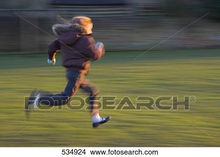 Girl with parka running over meadow, motion blur View Large Photo Image Picture - Girl with parka running over meadow, motion blur . Fotosearch