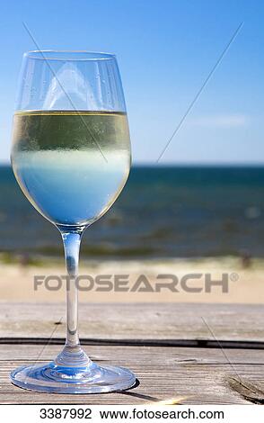 Glas of white wine on wooden board in front of sea, Wenningstedt-Braderup, Sylt, Germany View Large Photo Image Stock Image - Glas of white wine on wooden board in front of sea, Wenningstedt-Braderup, Sylt, Germany . Fotosearch