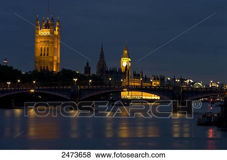 Stock Photo - Government building at waterfront, Thames River, Big Ben, Houses Of Parliament, City Of Westminster, London, England . Fotosearch