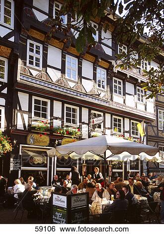 Stock Photograph - Group of people sitting at sidewalk cafe, Germany, Europe . Fotosearch