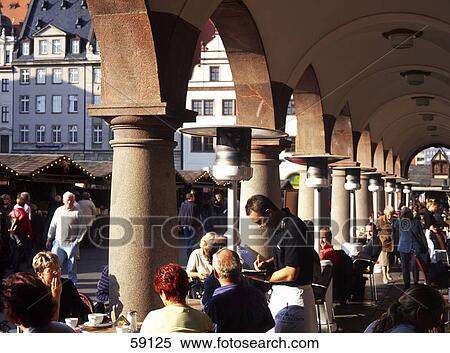 Stock Photography - Group of people sitting at sidewalk cafe, Saxonia, Germany, Europe . Fotosearch