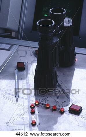 Stock Image - High angle view of binoculars on map . Fotosearch