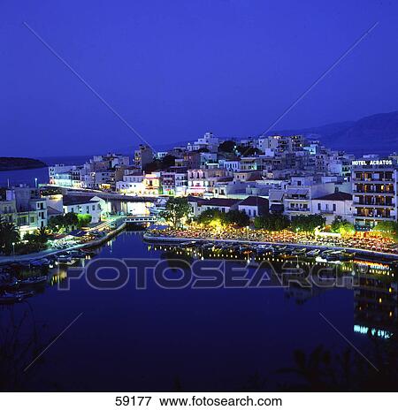 Stock Photo - High angle view of cityscape illuminated at night, Greece, Europe . Fotosearch
