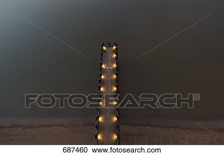 High angle view of pier lit up at night, Thames River, London, England View Large Photo Image Stock Image - High angle view of pier lit up at night, Thames River, London, England . Fotosearch