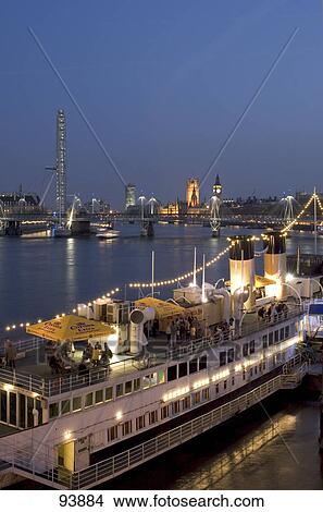 High angle view of restaurant boat in Thames River with government building in background, House of Parliament, London, England View Large Photo Image Picture - High angle view of restaurant boat in Thames River with government building in background, House of Parliament, London, England . Fotosearch
