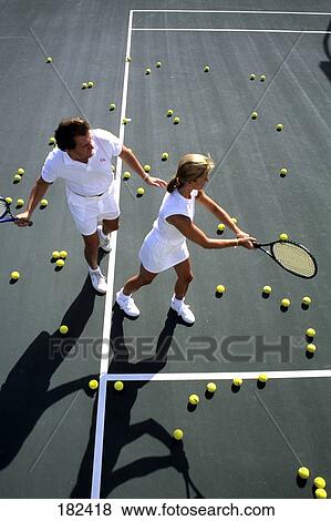 Stock Photo - High angle view of two tennis players practicing . Fotosearch