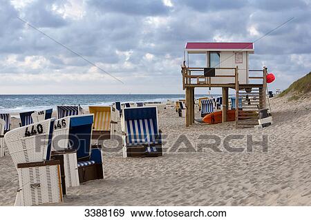 Stock Photo - Hooded Beach Chairs and water rescue at the beach of Rantum, Sylt, Germany . Fotosearch