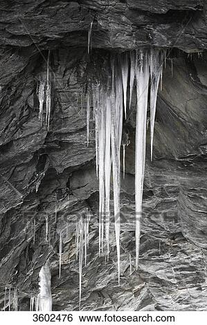 Stock Photograph - Iciles hanging from rock, Wallis, Switzerland . Fotosearch