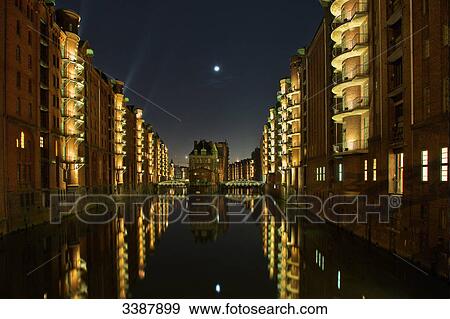 Stock Photo - Illuminated houses in the old warehouse district (Speicherstadt), Hamburg, Germany . Fotosearch