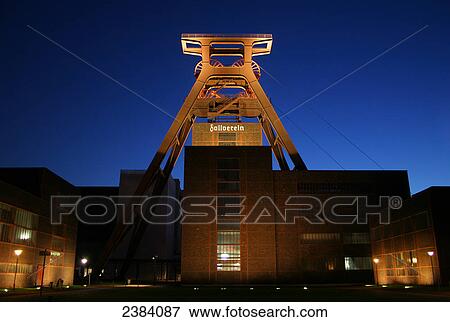Industrial monument lit up at dusk, Zollverein Coal Mine Industrial Complex, Essen, North Rhine-Westphalia, Germany View Large Photo Image Stock Photo - Industrial monument lit up at dusk, Zollverein Coal Mine Industrial Complex, Essen, North Rhine-Westphalia, Germany . Fotosearch