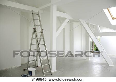 Stock Photography - Ladder and paint bucket in an empty attic flat . Fotosearch